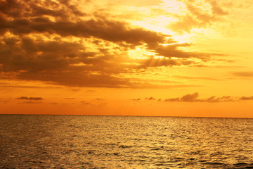 Beautiful sunrise at sea. The sea in the foreground. Background