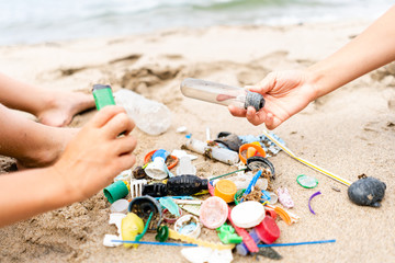 Children Sorting Through Plastic Waste on a Beach