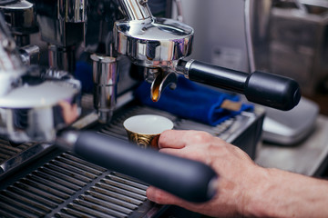 Coffee flowing into a cup from espresso machine