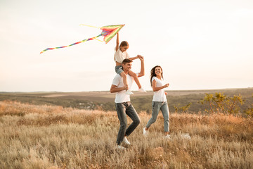 Playful casual family having fun together at countryside