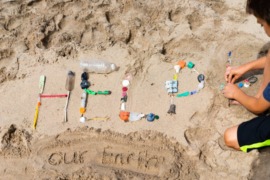 'Help Our Earth' Spelled on Beach with Plastic