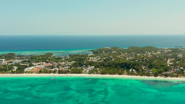 Tropical white sand beach, hotels near the blue lagoon and corall reef. aerial view, Boracay, Philippines. Seascape with beach on tropical island. Summer and travel vacation concept.
