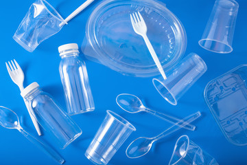 single use plastic bottles, cups, forks, spoons. concept of recycling plastic, plastic waste