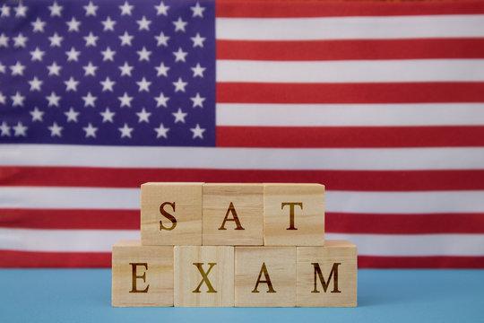 SAT Exam in WOoden blook letters on US flag