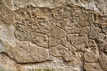 Original background of natural ancient large stone on the wall with the texture of cracks and bricks
