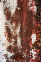 Original background of natural cement plaster on red textured wall with cracks