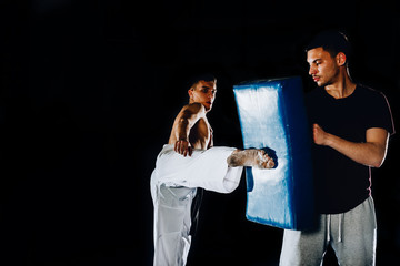 Two boxers practicing punching techniques in sports club