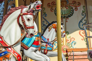 Carousel with rocking horses close up