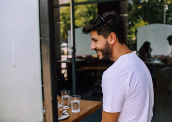 Fototapeta na wymiar Portrait of smiling man sitting in coffee bar