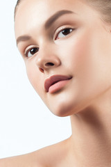 Young beautiful woman with clean perfect skin close-up