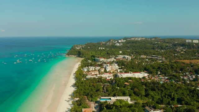 Tropical white sand beach, hotels near the blue lagoon and corall reef. aerial view, Boracay, Philippines. Seascape with beach on tropical island. Summer and travel vacation concept.