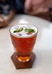 Cold ice tea with mint leaf on the top