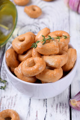 Italian snack Tarallini with herbs and garlic in a white ceramic bowl