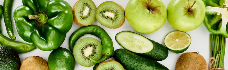 panoramic shot of peppers, cucumbers, kiwi, lime, apples and avocado