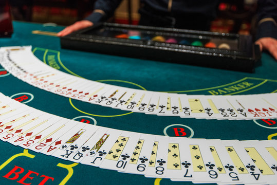 Professional Croupier During Cards Shuffle In The Casino