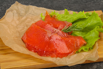 Sliced salmon fillet served rosemary