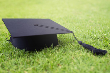 shot of graduation hats on the grass, concept during commencement success graduates of the...