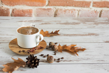 Cup of black coffee in autumn background. Copy space.