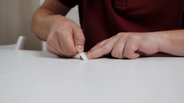 A man takes care of his nails at home. Beauty, care, health