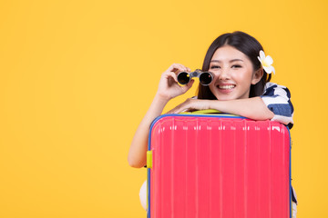 Tourist woman in summer casual clothes.Asian Smiling woman .Passenger traveling abroad to travel on yellow background.She going to summer vacation.Travel trip funny  on holiday.