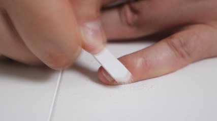 A man takes care of his nails at home. Beauty, care, health