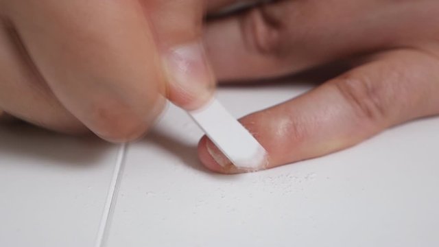 A man takes care of his nails at home. Beauty, care, health