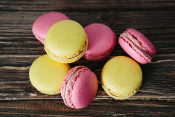 Sweet colorful French macaroon cookies dessert on brown wooden table