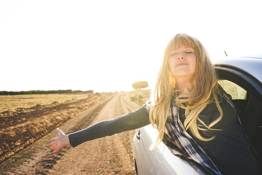Young woman in a road trip enjoying the journey