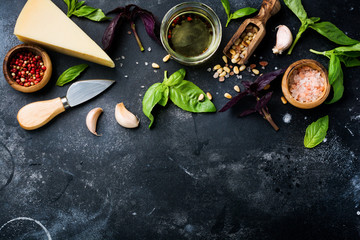 Ingredients for making traditional italian pesto sauce on old dark rustic background. Flat lay.