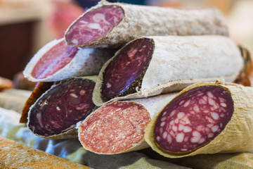 Sticks of sliced ​​fresh sausage in an opaque package.