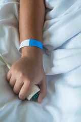 Patient in hospital in bed with emergency button