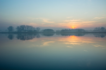 Hazy blue lake and sunset