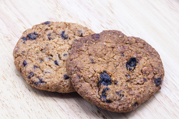 Tasty Chocolate chip cookies on wooden plate background.
