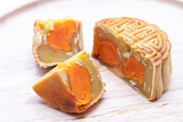 Close up of Chinese moon cake on wooden plate background.Mid autumn festival.
