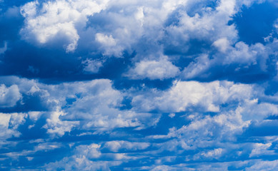 Naklejka na ściany i meble White clouds on a blue sky in summer.