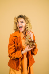 Fashion trends for fall. Autumn Clothing and color trends. Leaf fall. Beautiful young girl with autumn leaf. Autumn woman with golden leaves. Autumnal foliage. Autumn sale. Fashion woman with leaves.