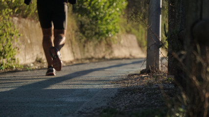 running at the park with a warm morning light, runner on a blurry country background