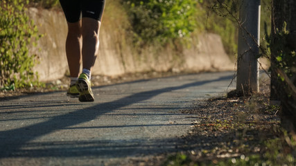 Obraz premium running at the park with a warm morning light, runner on a blurry country background