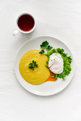 Fodmap diet, poached egg benedict with polenta and parmesan cheese, healthy breakfast