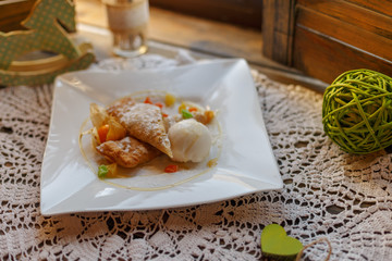 cake on a white plate on an embroidered napkin on the windowsill