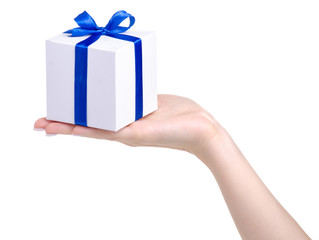 White box with blue ribbon bow gift in hand on white background isolation