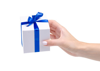 White box with blue ribbon bow gift in hand on white background isolation