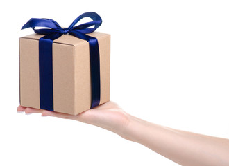 Brown box with blue ribbon bow gift in hand