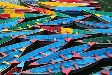 Fototapeta na wymiar Colorful boats in Nepal on a lake