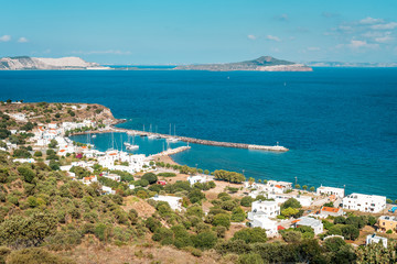 Fototapeta na wymiar Coastal town in Greece with harbor, view to Aegean Sea, marina with sail boats, Pali, Nisyros Island, Greece