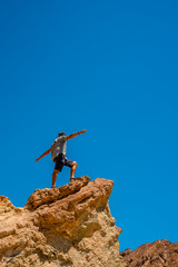 A man on the Golden Canyon trail on top of a beautiful stone, California. United States