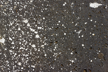 drops of white paint on cement stone floor