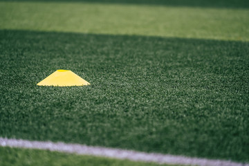 Soccer sport training equipments marker on green outdoor soccer training field