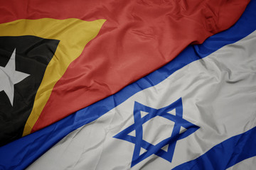 waving colorful flag of israel and national flag of east timor.
