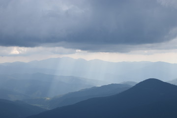 Fototapeta na wymiar View while climbing Mount Hoverla. View of the mountain, forests and clouds. Ukrainian Carpathians.